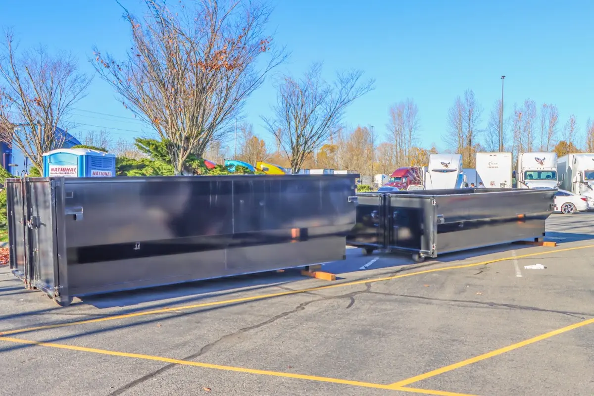 Professional dumpster rental service with roll-off container on residential driveway in Lewisburg